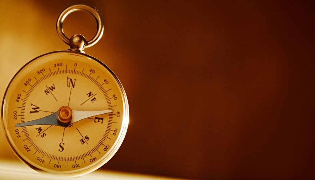 a compass on a warm brown background